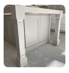 an unfinished kitchen island with white cabinetry and counter tops in the process of being painted