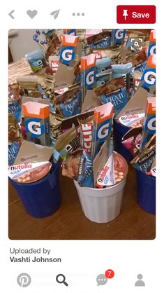 several buckets filled with snacks sitting on top of a wooden table