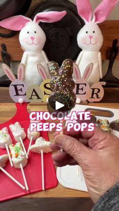 someone is holding up some chocolate peeps pops with bunny ears on them and the words easter