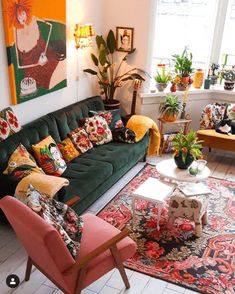 a living room filled with furniture and lots of plants