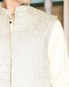 This off-white kurta pajama set is paired with an embroidered ethnic long Nehru jacket. The jacket has a front zipper opening with side slits on both sides. The traditional pastel-colored embroidery at the border of the jacket enhances the entire look. Paired it up with a velvet jutti and draped a simple satin dupatta for a royal and classic look. Product color may slightly vary due to photographic lighting sources or your screen settings. Shoes and accessories are only for photoshoot purpose. Q Satin Dupatta, Wedding Kurta, Simple Satin, Off White Jacket, White Kurta, Nehru Jacket, Kurta Pajama, Polyester Jacket, Nehru Jackets