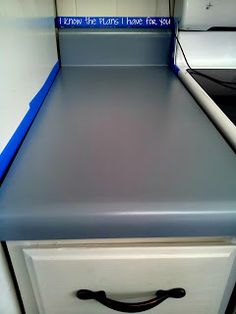 an empty stove top in a kitchen with blue trim