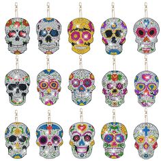 a bunch of different colored skulls hanging from chains