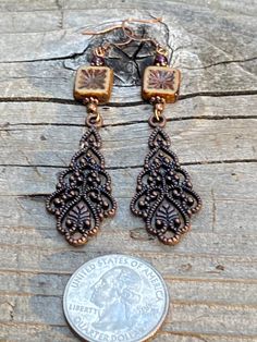 Long antique copper filigree earrings with Czech crystal and garnet gemstones. These long filigree earrings are very lovely, not too heavy! They are 3 inches long and 3/4 of an inch wide. The square table Kurt Czechoslovakian crystals really make the design pop. Garnet is the birthstone for January. All my jewelry comes gift boxed with a custom Shelly Mariposa Design butterfly card ready for gift giving, whether it is a gift for you or someone special. Your satisfaction is very important to me. Antique Gold Copper Earrings With Antique Finish, Antique Finish Copper Drop Earrings, Antique Finish Copper Dangle Earrings, Antique Finish Copper Earrings As Gift, Handmade Antique Copper Earrings, Antique Copper Drop Earrings, Antique Copper Earrings In Antique Gold, Antique Copper Dangle Earrings, Antique Copper Earrings For Gift