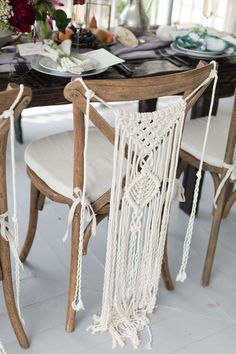 a dining room table decorated with macrame and flowers