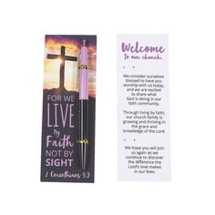 a bookmark with a cross on it and a pen in front of it that says, for we live by faith not by sight