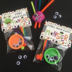 two plastic bags filled with monster magnets on top of a black table next to other items