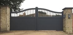 an iron gate with brick pillars and gates