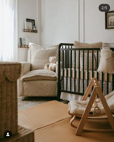 a baby's room with a crib, rocking chair and teddy bear in the corner