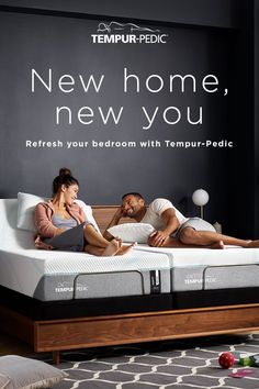 a man and woman laying on top of a bed in front of a sign that says new home, new you