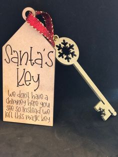 a key is attached to a sign that says santa's key