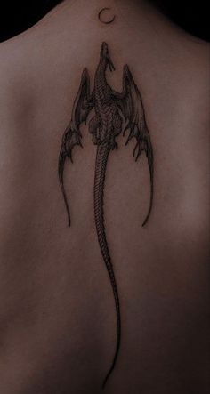 a woman with a dragon tattoo on her back