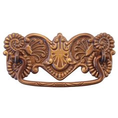 an ornate brass drawer pull handle on a white background