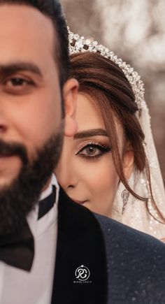 a man in a tuxedo and a woman with a veil on their head