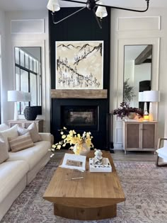 a living room filled with furniture and a large painting on the wall above it's fireplace