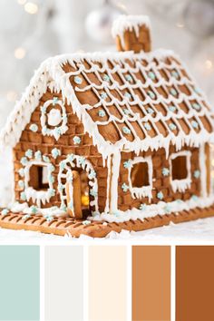 a gingerbread house decorated with icing and frosting on top of a table