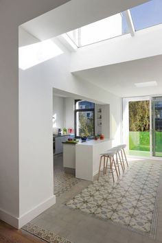 an open kitchen and dining room with skylights