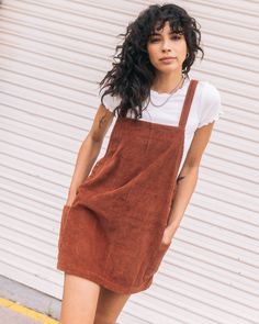 Crafted from soft, durable corduroy, this loose-fitting brown corduroy dress features adjustable overall straps, metal hardware, and pockets for function and flair. The stone embroidery adds a signature touch to this vintage-inspired piece. - 
 - 100% Cotton 6 Wale Corduroy, 310GSM
 - Loose fitting dress with adjustable overall straps
 - Metal overall hardware throughout
 - Patch pockets at sideseams
 - Stone embroidery at front below pocket Brown Corduroy Dress, Overall Straps, Stone Embroidery, Power Chord, Fitting Dress, Brown Corduroy, Loose Fitting Dresses, Corduroy Dress, Chestnut Brown