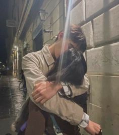 a man is hugging a woman on the street