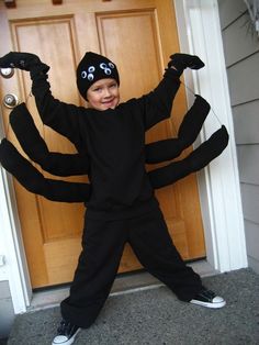 a young boy dressed up as a spider