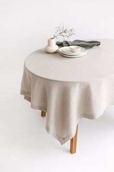 a table with a white plate and black napkin on it