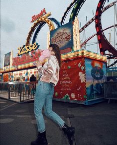 a woman walking in front of a carnival ride with her hand on her hip and the caption people often say that motivation doesn't