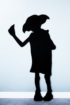 a shadow of a person standing in front of a wall