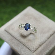 a blue ring sitting on top of a white box