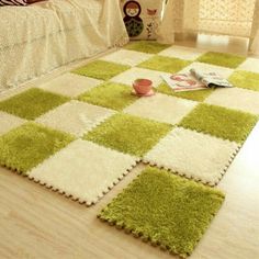 a green and white area rug on the floor in a living room with a bed