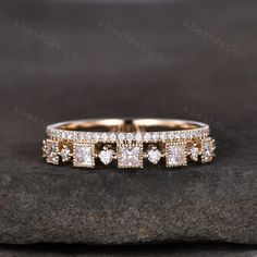 an image of two wedding rings on top of a rock with diamonds in the middle