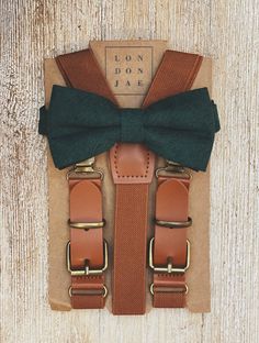 Cognac Brown Buckle Suspenders with Dark Green Cotton Bow Tie Set – London Jae Apparel Dark Green Groomsmen Attire Suspenders, Green Bow Tie Outfit Men, Dark Green Ring Bearer Outfit, Dark Green Boho Wedding, Groom Suspenders Bow Tie, Forest Green Groomsmen Attire, Dark Green Groomsmen Attire, Groomsmen Attire Suspenders, Brown And Green Wedding