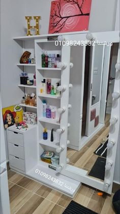 a white cabinet with lots of items on it in front of a mirror and door