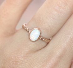 8x6mm simulated opal stone set onto a 14k rose gold filled bead band. Also available with a turquoise, rainbow moonstone, lab ruby, or a pink opal. All orders ship in a gift box. If you are ordering multiple items and want them boxed separately, please let me know in the notes at checkout. I ship via USPS. Please review the estimated delivery date and processing times. Processing times vary based on how busy my shop is at the time. **Stacking Ring Sizing - When you are stacking multiple rings yo Dainty Rose Gold Opal Jewelry, Oval Opal Stackable Jewelry, Stackable Oval Opal Jewelry, Adjustable Rose Gold Opal Jewelry, Adjustable Oval Opal Jewelry, Oval Opal Ring, Gold Opal Ring, Rose Gold Opal Ring, Birthstone Stacking Rings