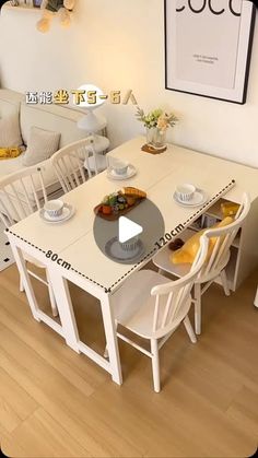 a white table with chairs around it in a room