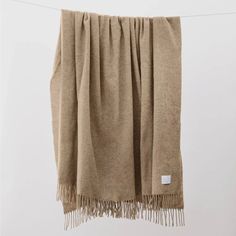 a tan blanket hanging from a clothes line