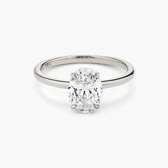 an oval cut diamond engagement ring on a white background, with the center stone visible