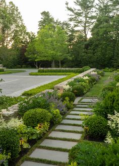 a stone path in the middle of a garden