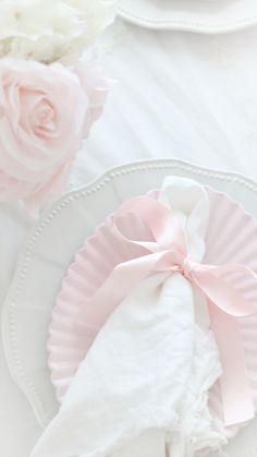 pink napkins and white plates with flowers on them