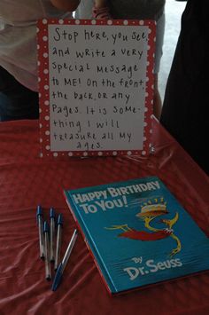 a birthday card and pens sit on a table next to a sign that says, happy birthday dr seuss