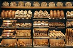 a bakery filled with lots of different types of bread