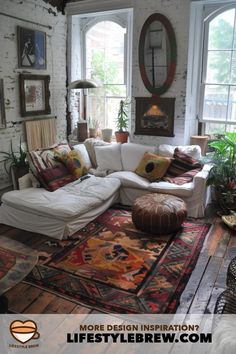 a living room filled with furniture and lots of windows