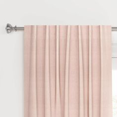 an open curtain with pink pleated curtains hanging on the side of a white wall