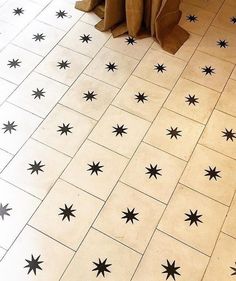 black and white stars are on the floor in this bathroom, while brown paper bags sit next to it