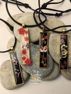 Designed with a nod to Japanese culture, these artisan necklaces are a tribute to the stunning landscapes and rich mythology of Japan. Though they might seem like the perfect accessory for 'the lads,' they are, in truth, crafted for anyone who appreciates beauty and artistry.  Made of resin, every detail in these necklaces has been meticulously handcrafted and thoughtfully assembled to capture the essence of Japanese aesthetics. Japanese Necklace Traditional, Hand Painted Spiritual Resin Jewelry, Hand Painted Resin Jewelry For Gifts, Red Artistic Design Jewelry For Gift, Black Jewelry With Artistic Design As Gift, Black Necklaces With Unique Variations As Gifts, Black Necklace With Unique Variations For Gift, Artistic Flower Pendant Jewelry Gift, Artistic Red Pendant Jewelry