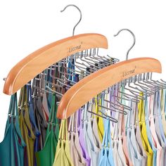 several umbrellas are hanging on a rack with wooden hangers in front of them