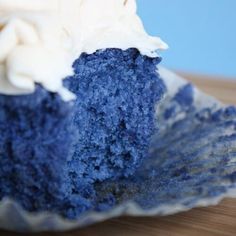 a piece of blue cake with white frosting