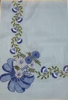 a blue and white flowered design on a light blue background with green stems, leaves and flowers