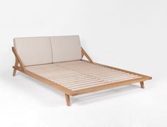 a wooden bed frame with two pillows on the top and bottom sides, against a white background