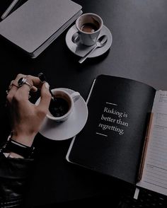 a person sitting at a table with a book and cup of coffee