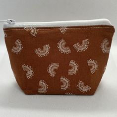 View this super cute flat bottom pouch! Use it to hold change and money, credit cards, earbuds, jewelry, and other small essential items. Click to shop now! ❤︎ Description ❤︎ -> Size: approximately 4 in x 5 in x 1.5 in -> Please allow for some stitching and fabric placement variations. This zipper cosmetics bag is designed with a flat bottom for more storage. Use it to store smaller items such as credit cards, jewelry, makeup, masks, feminine hygiene products, and more! It fits perfectly in purses, bags, and backpacks. Purchase today to get this versatile, cute, accessories holder!   ❤︎ Note to Buyer ❤︎ All products are handmade and if you have any questions, please don't hesitate to reach out! I want to make sure that you will receive a product that you'll love!  ❤︎ Shop Homepage ❤︎ http: Trendy Brown Pouch Coin Purse, Handmade Bohemian Brown Pouch, Bohemian Hand-stitched Pouch Bag, Bohemian Pouch Coin Purse, Bohemian Cosmetic Bag With Zipper, Rectangular Shape, Small Zipper Pouch, Cute Flats, Feminine Hygiene, Accessories Holder